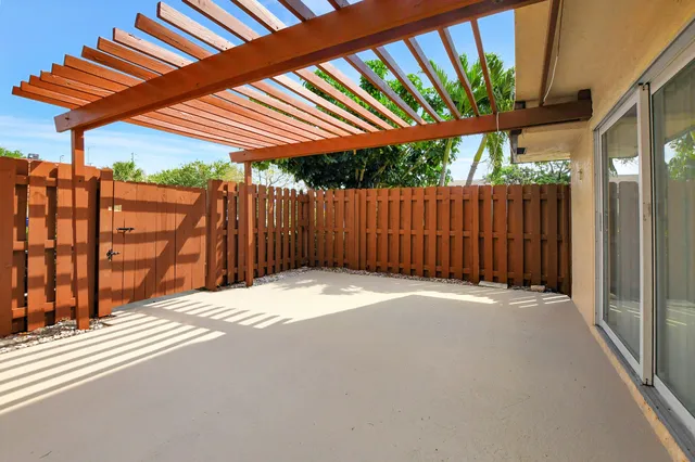 a view of a backyard with wooden fence