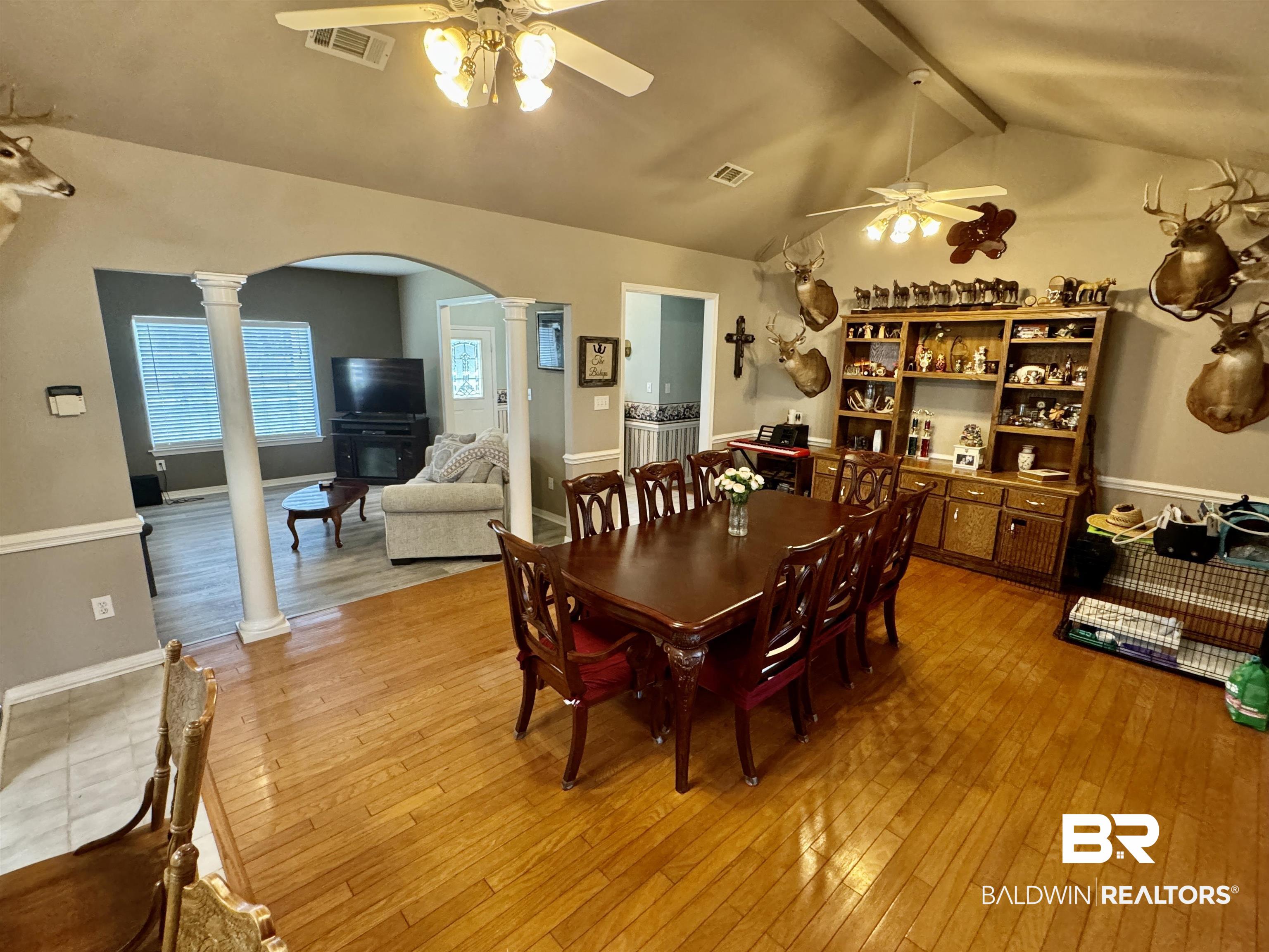 13795 White Road Silverhill, AL 36576 - Photo 27 of 99 Dining space with ornate columns, light wood-style floors, a ceiling fan, and beamed ceiling