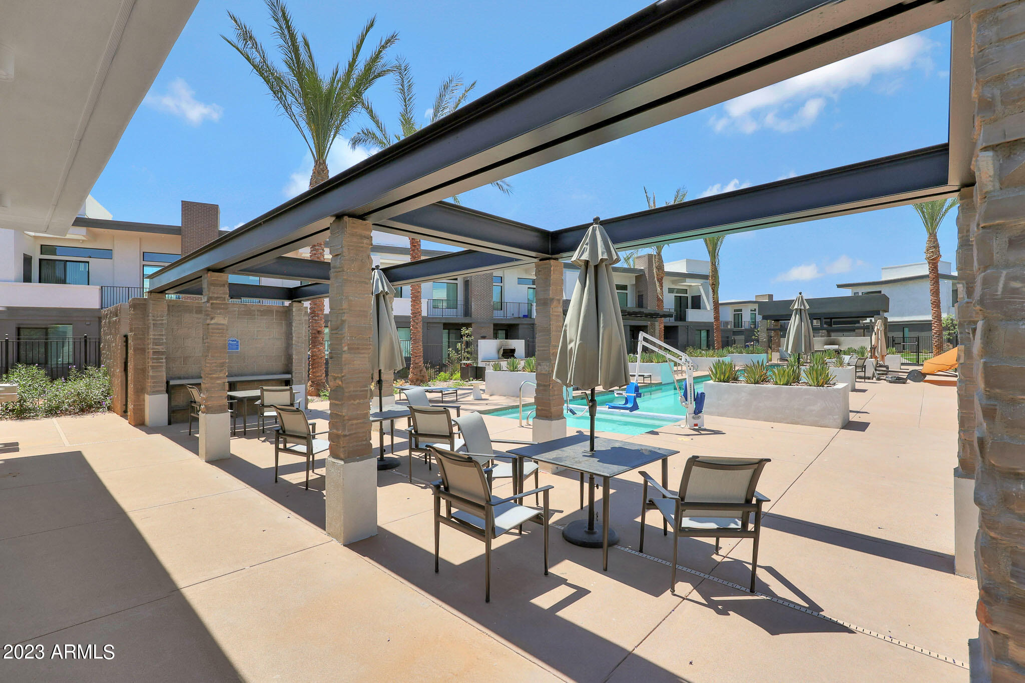 6060 East Baseline Road, Unit 170 Mesa, AZ 85206 - Photo 32 of 45 a building outdoor space with patio furniture and potted plants