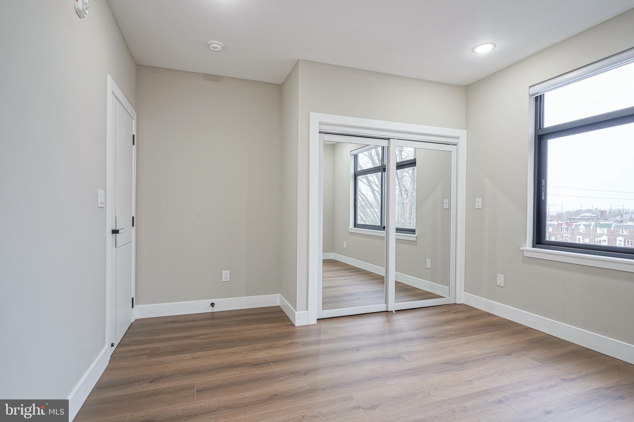 4432-00 Wingate Street, Unit 305 Philadelphia, PA 19136 - Photo 12 of 19 an empty room with wooden floor and windows