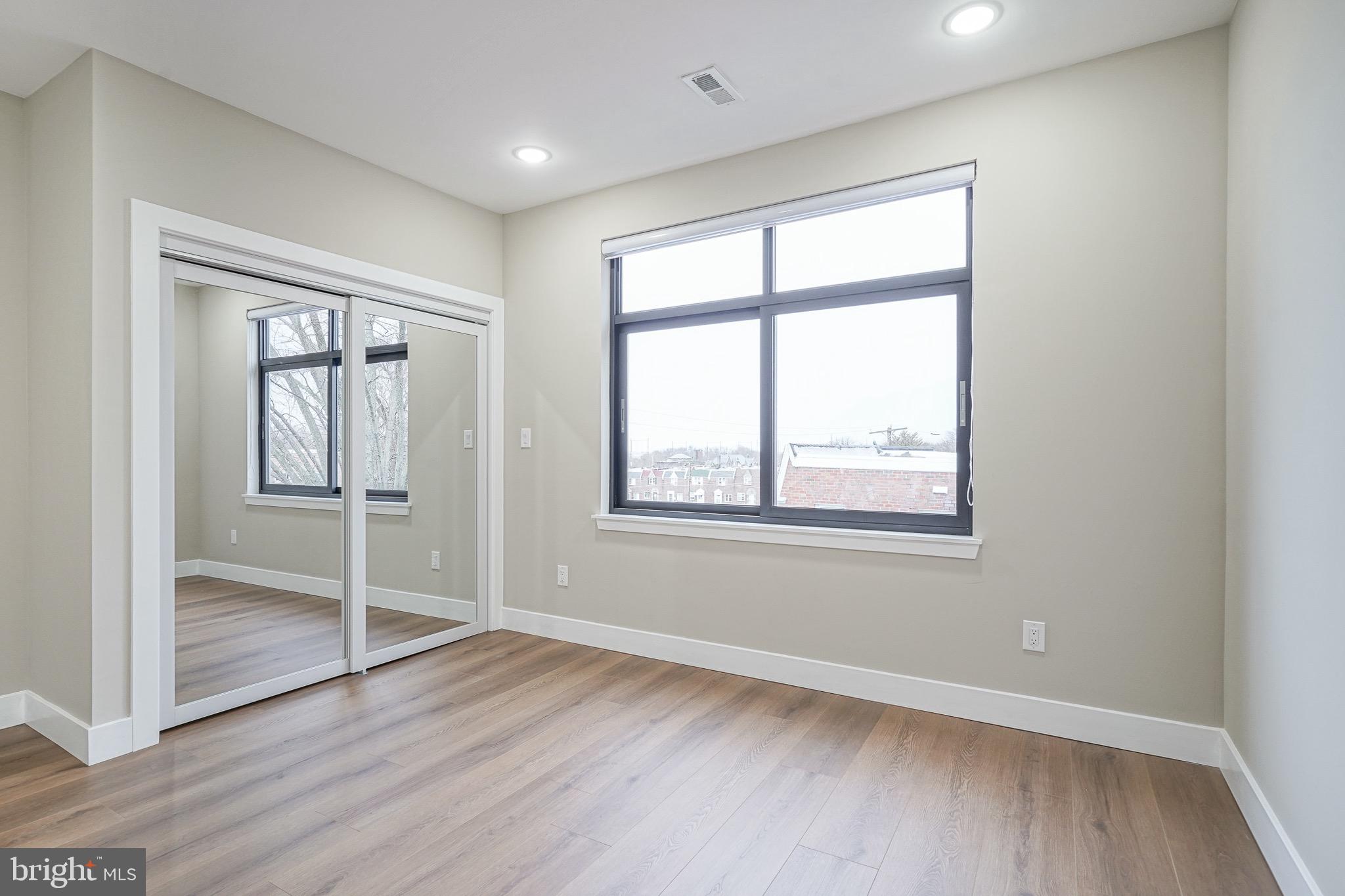 4432-00 Wingate Street, Unit 305 Philadelphia, PA 19136 - Photo 13 of 19 an empty room with wooden floor and windows