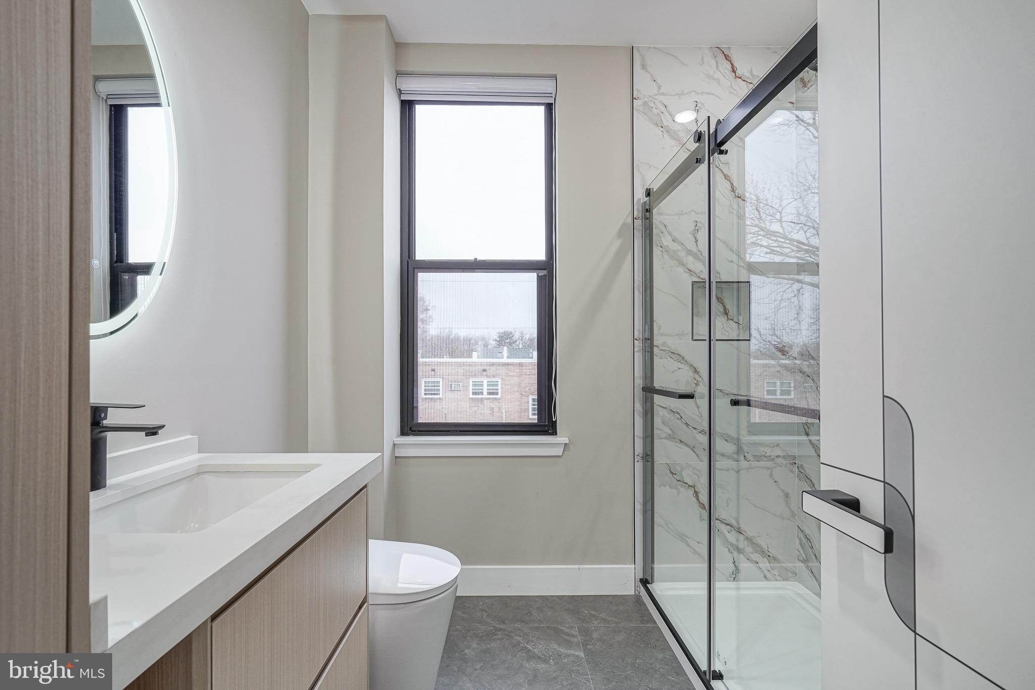 4432-00 Wingate Street, Unit 305 Philadelphia, PA 19136 - Photo 15 of 19 a bathroom with a sink a toilet and shower