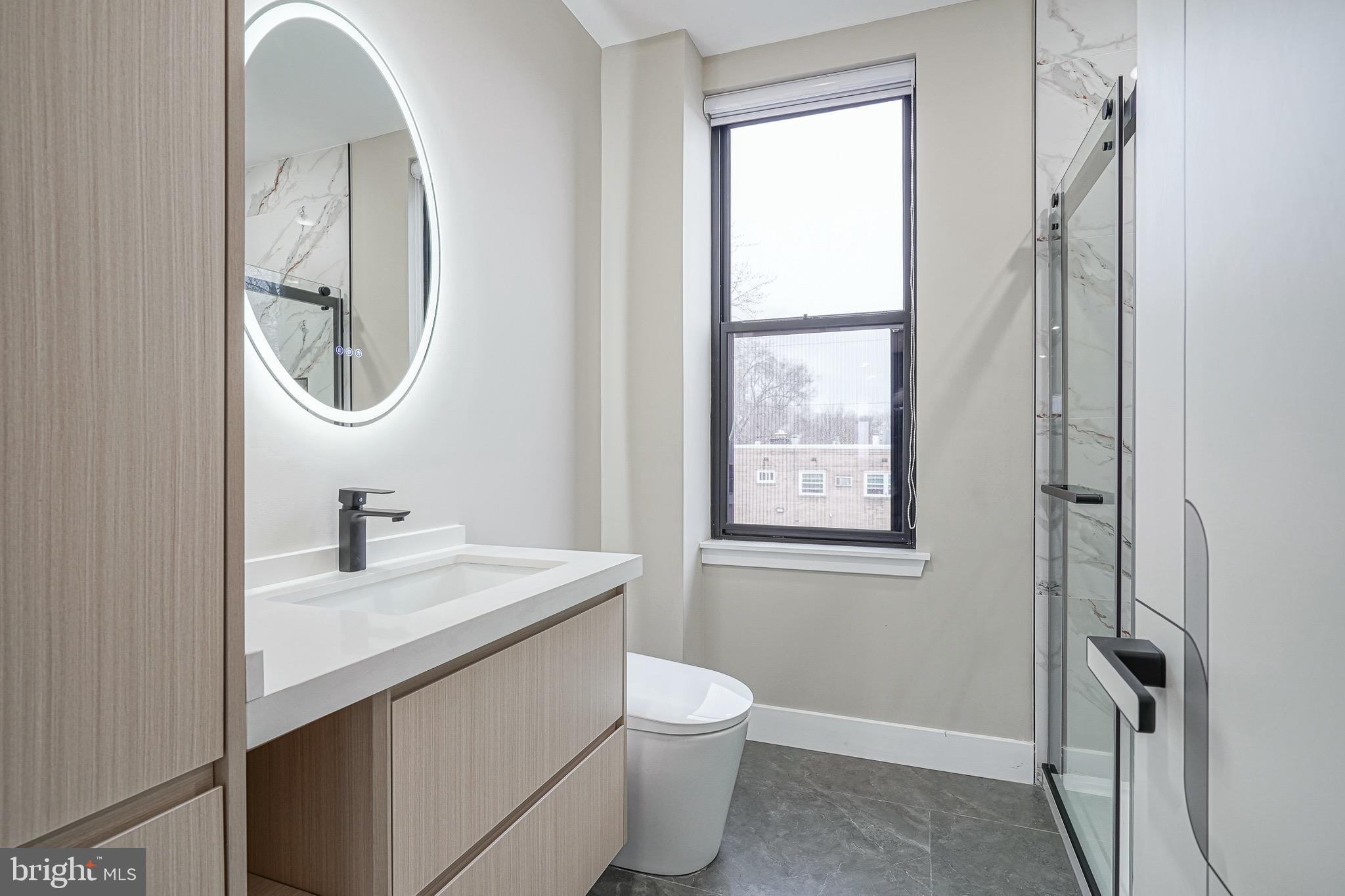 4432-00 Wingate Street, Unit 305 Philadelphia, PA 19136 - Photo 16 of 19 a bathroom with a toilet a sink and a mirror