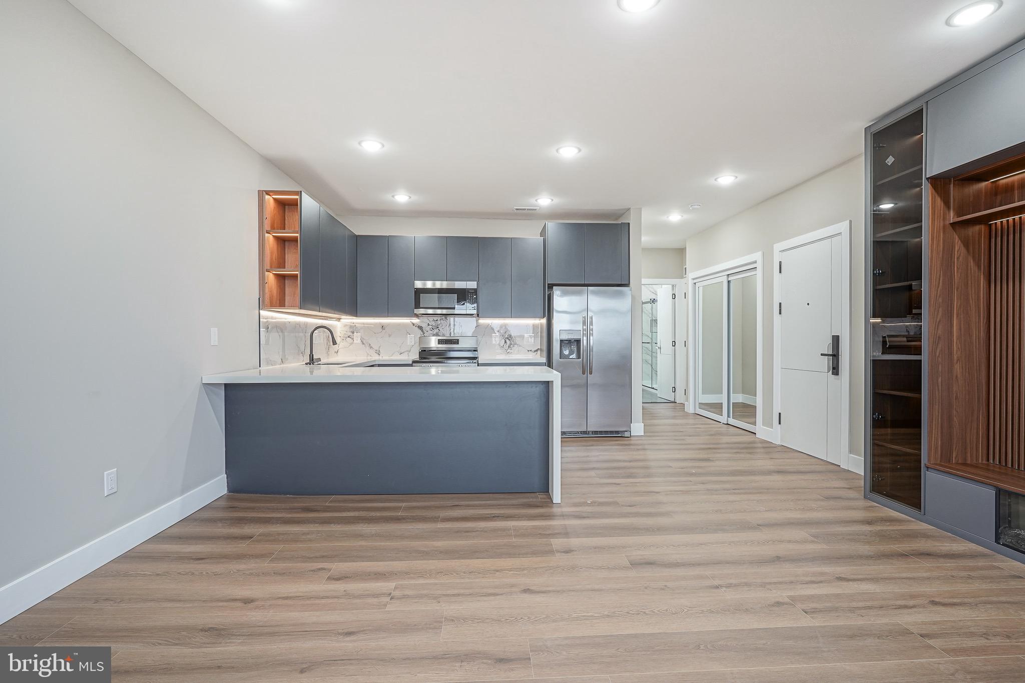 4432-00 Wingate Street, Unit 305 Philadelphia, PA 19136 - Photo 4 of 19 a view of kitchen cabinets and wooden floor
