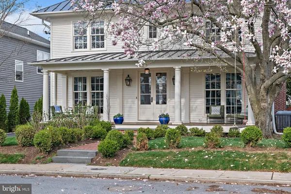 a view of a house with backyard sitting area and garden