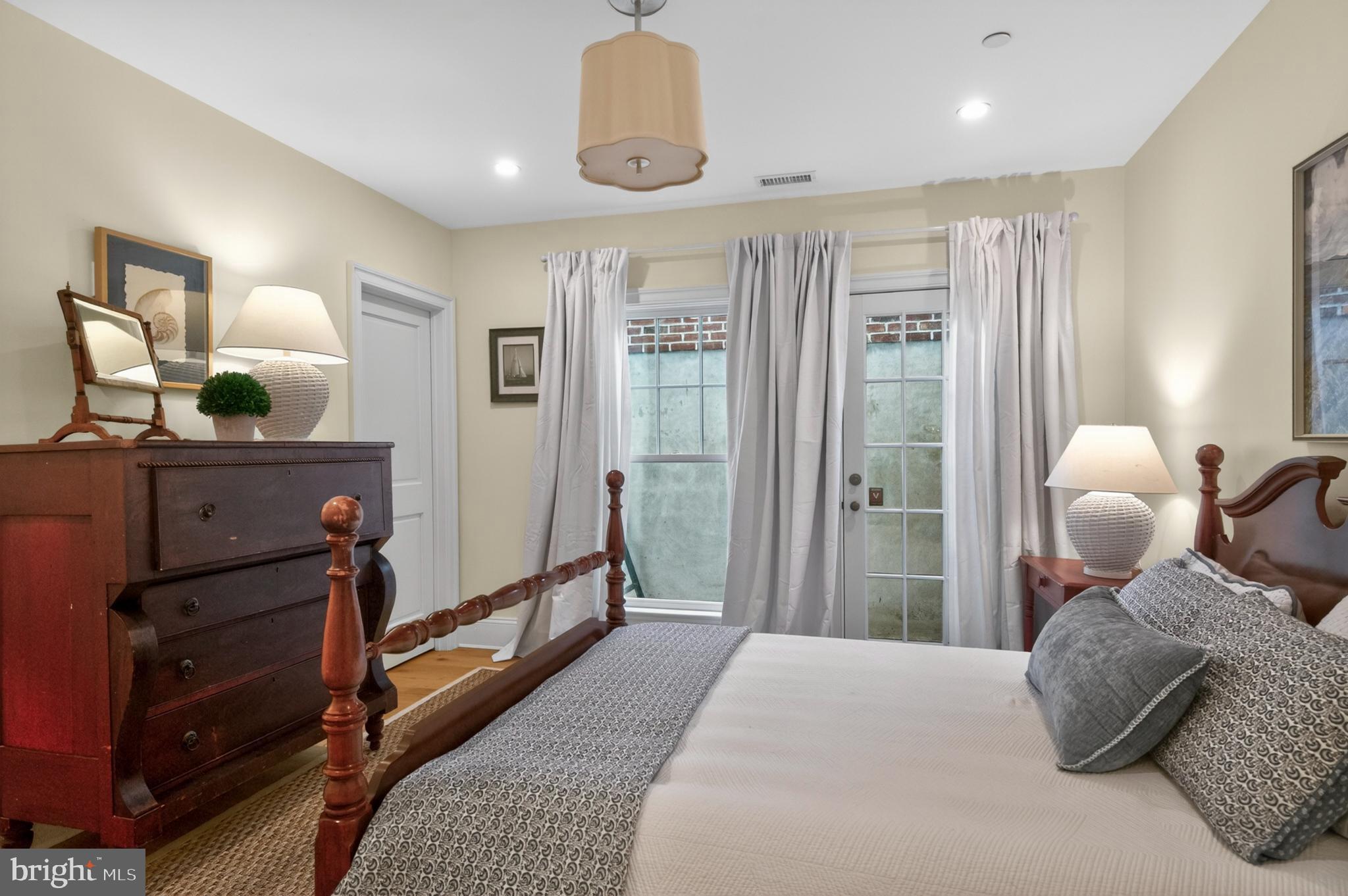 313 Washington Street Annapolis, MD 21403 - Photo 85 of 114 a bedroom with a bed and wooden floor