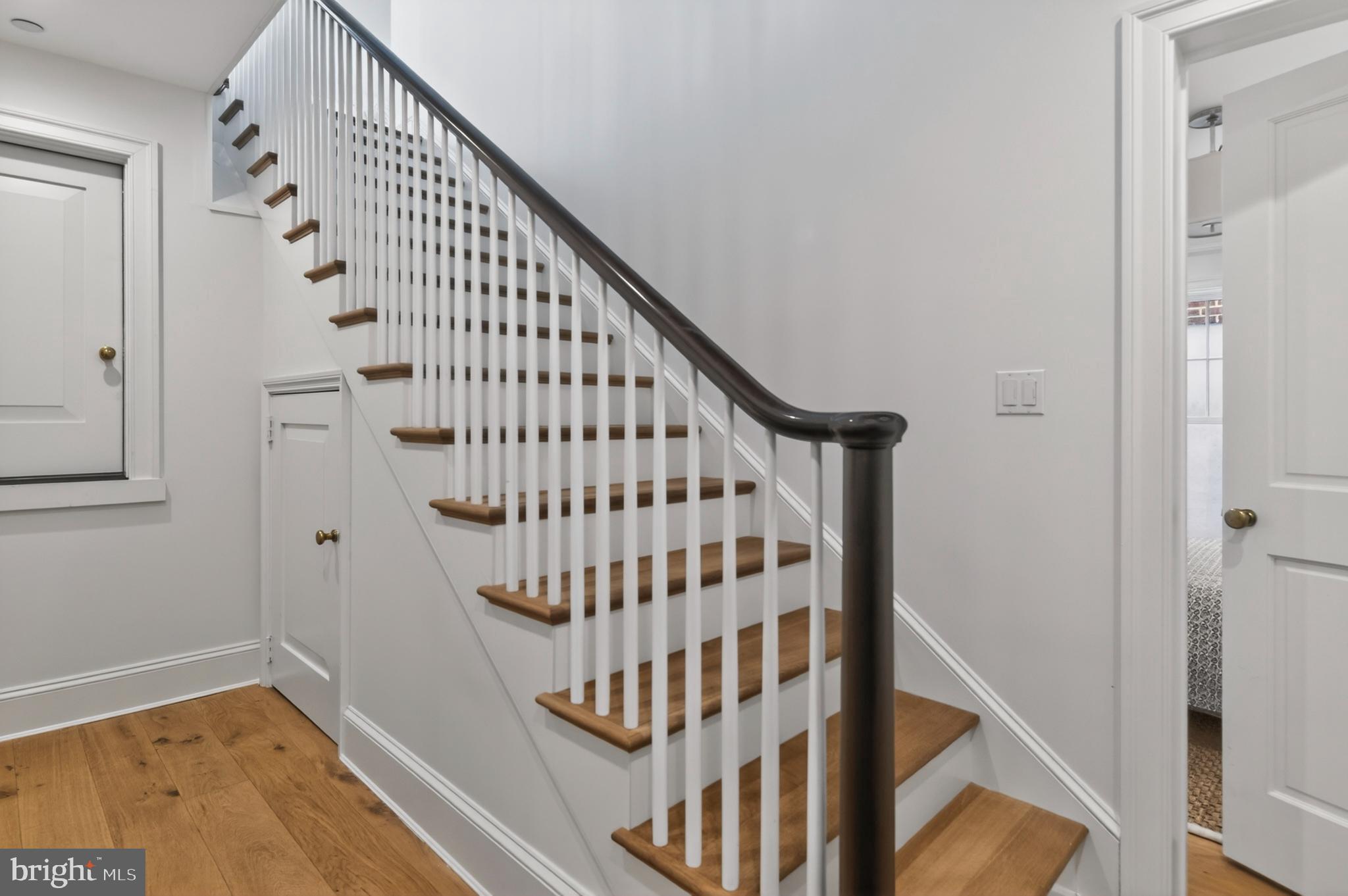 313 Washington Street Annapolis, MD 21403 - Photo 88 of 114 a view of staircase with wooden floor and white walls