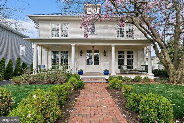 a front view of a house with a yard and porch