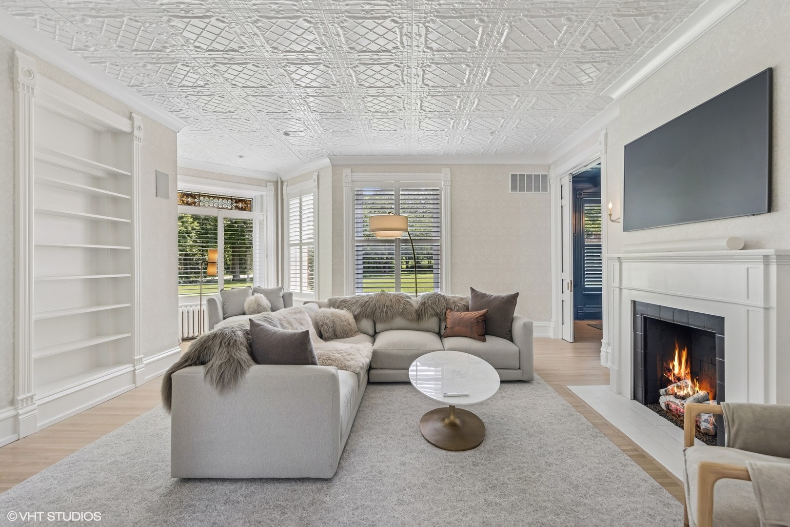 31W141 Army Trail Road Wayne, IL 60184 - Photo 11 of 51 a living room with furniture a flat screen tv and a fireplace