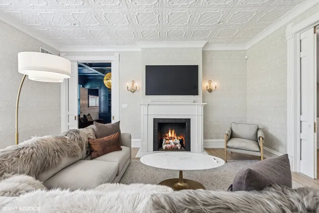 a living room with furniture a fireplace and a flat screen tv