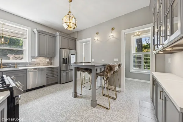a kitchen with a refrigerator sink and cabinets
