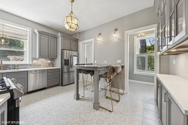 a kitchen with a refrigerator sink and cabinets