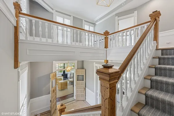 a view of a hallway with wooden floor and stairs