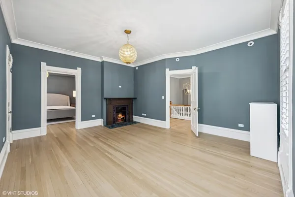 a bedroom with a bed and painting on the wall
