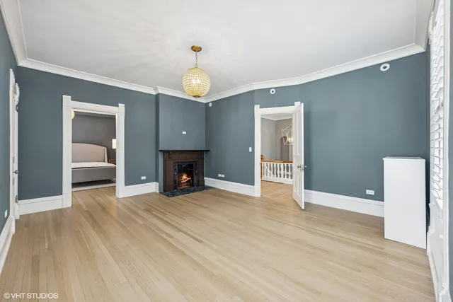 a bedroom with a bed and painting on the wall