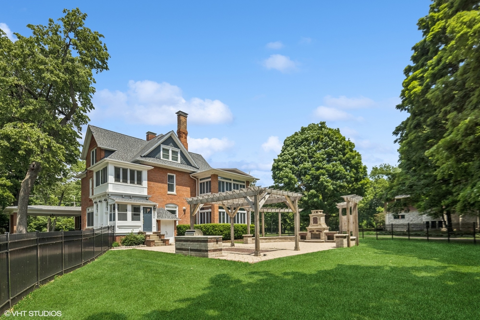 31W141 Army Trail Road Wayne, IL 60184 - Photo 4 of 51 a front view of a house with a yard table and chairs