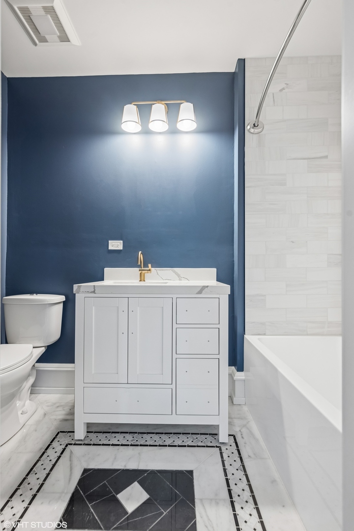 31W141 Army Trail Road Wayne, IL 60184 - Photo 43 of 51 a bathroom with a sink a toilet and bathtub