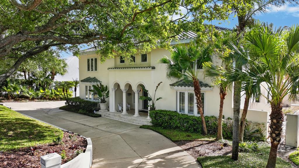 70 Riverside Drive Ormond Beach, FL 32176 - Photo 13 of 68 a front view of a house with a yard and potted plants