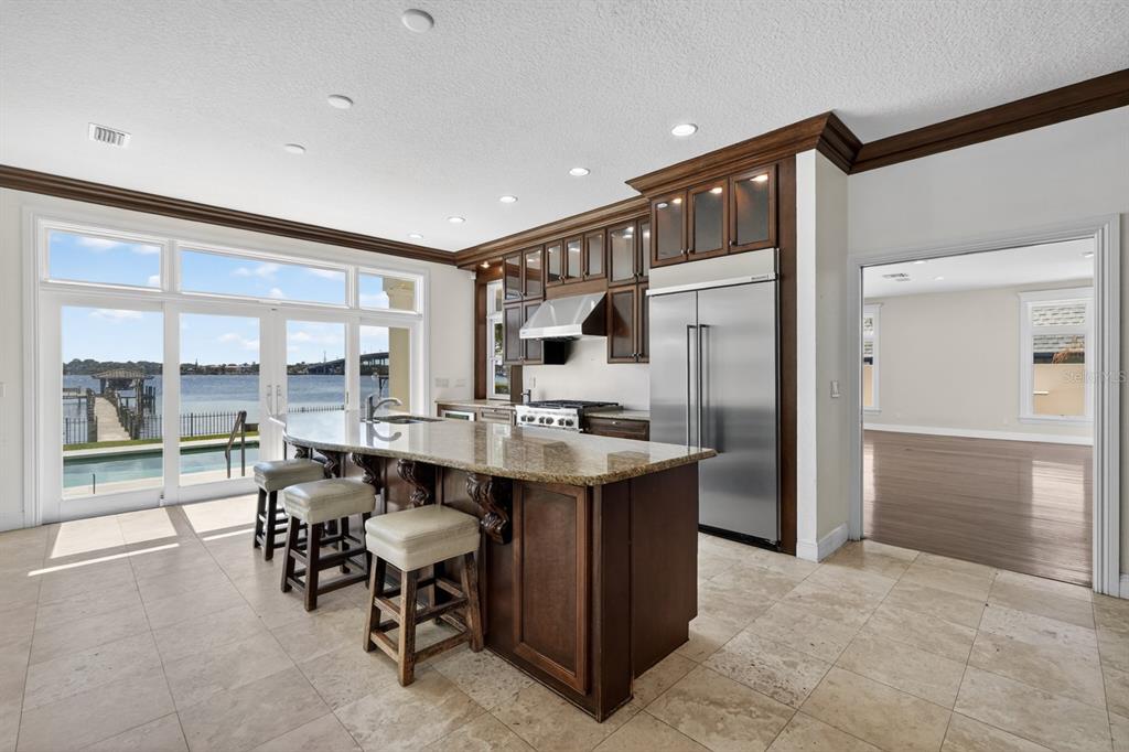 70 Riverside Drive Ormond Beach, FL 32176 - Photo 27 of 68 a open kitchen with stainless steel appliances granite countertop a table chairs and a refrigerator