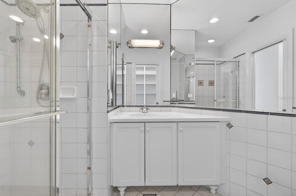 70 Riverside Drive Ormond Beach, FL 32176 - Photo 54 of 68 a bathroom with a granite countertop sink a mirror and shower