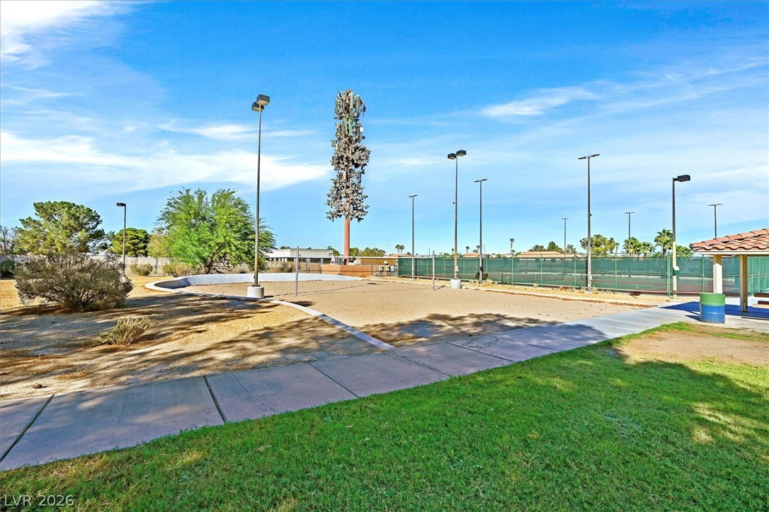 8830 Haviland Road Las Vegas, NV 89123 - Photo 33 of 43 Concrete walkways border outdoor recreation courts set against a clear blue sky.