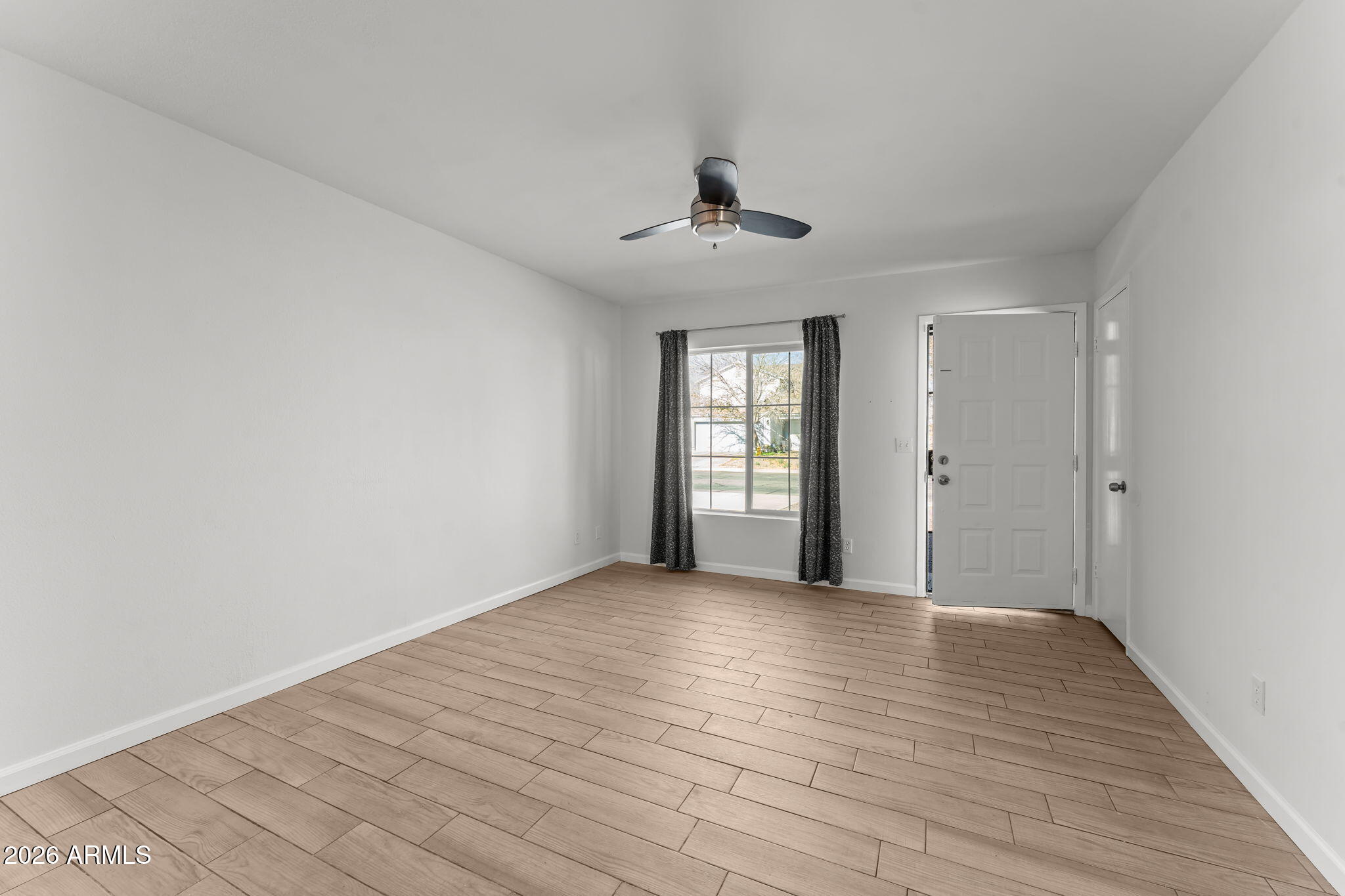 9257 West Gary Road Peoria, AZ 85345 - Photo 10 of 28 wooden floor in an empty room with a window