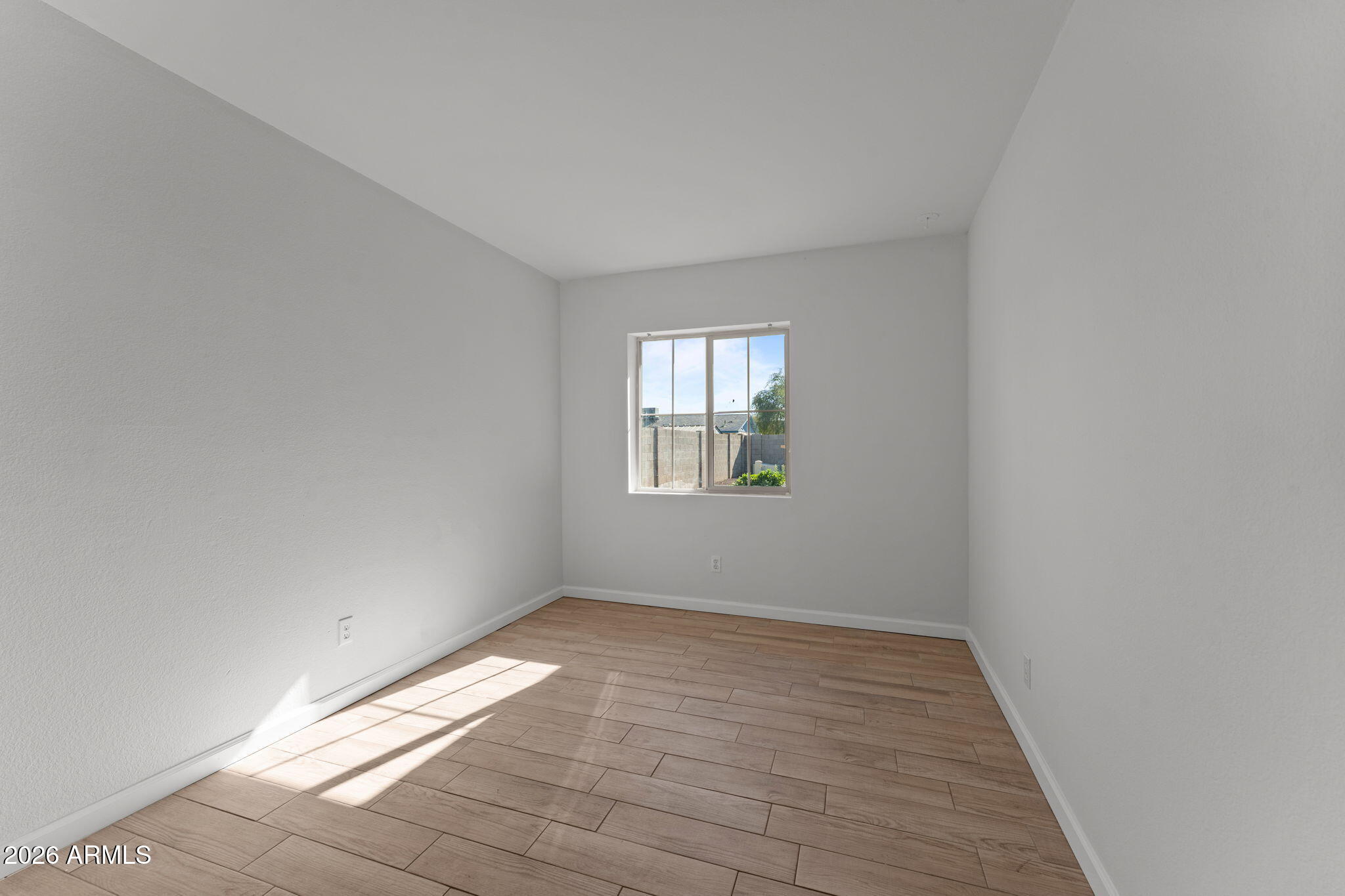 9257 West Gary Road Peoria, AZ 85345 - Photo 14 of 28 wooden floor in an empty room with a window