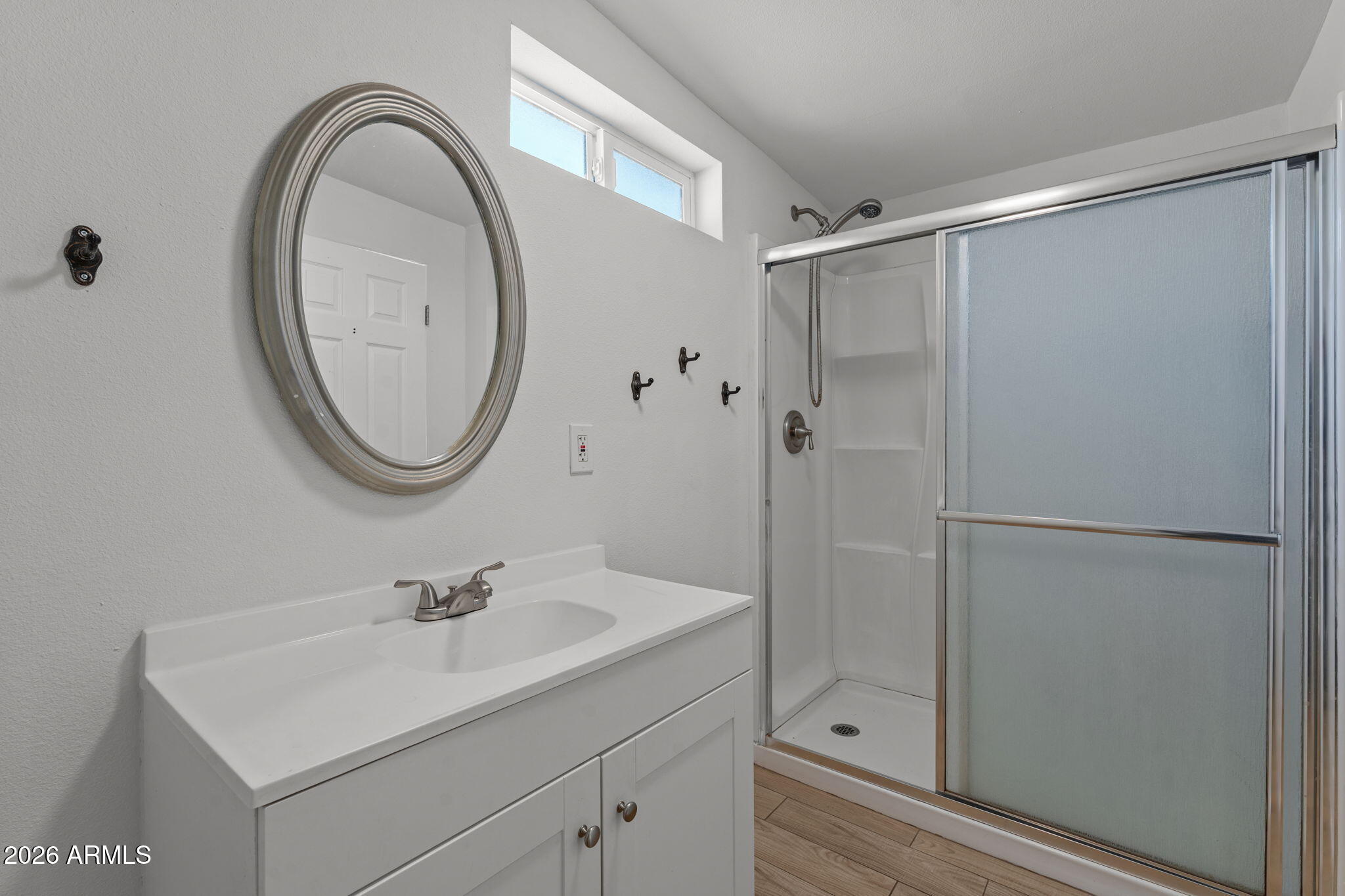9257 West Gary Road Peoria, AZ 85345 - Photo 15 of 28 a bathroom with a sink a mirror a vanity and a shower