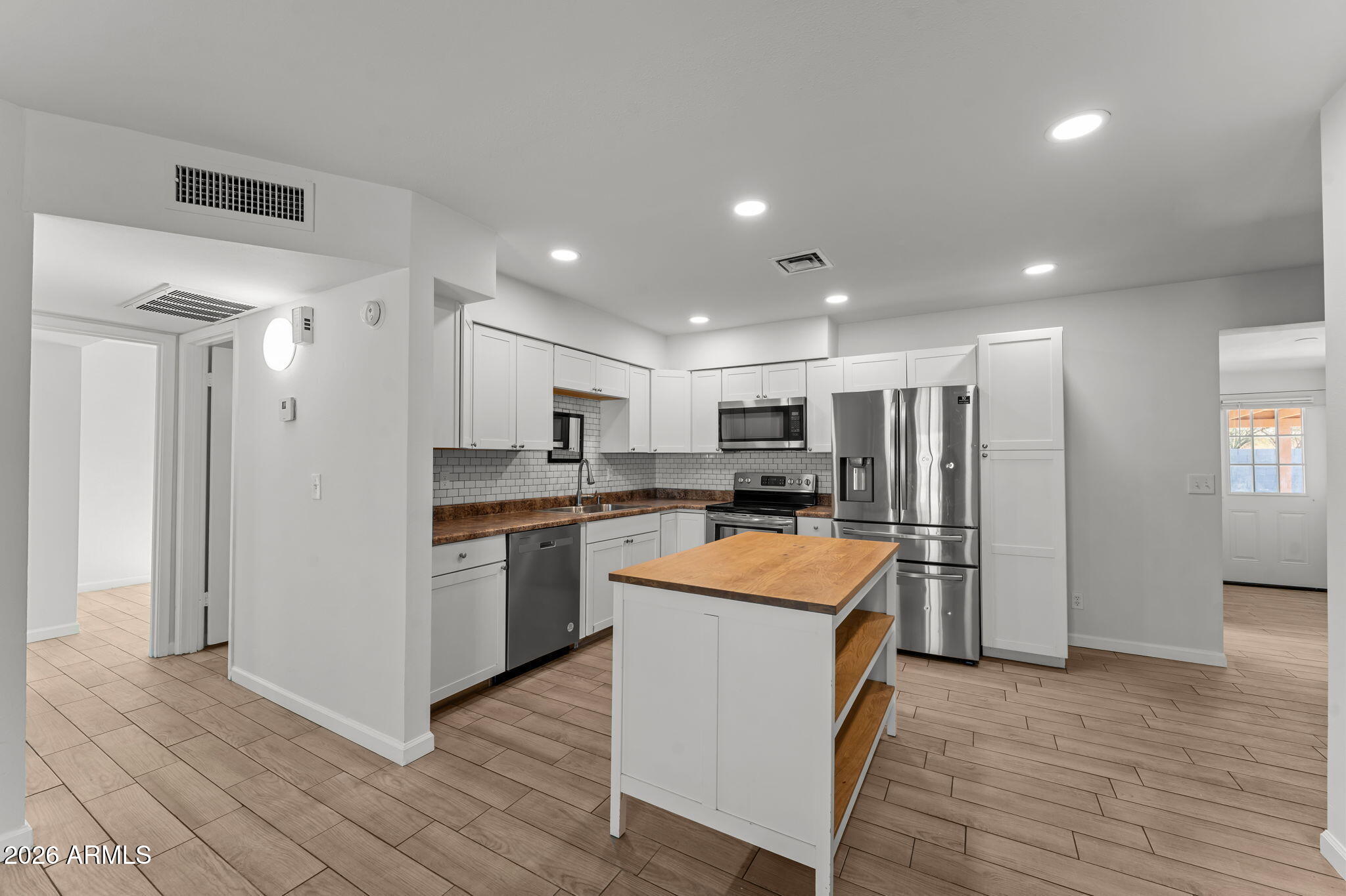 9257 West Gary Road Peoria, AZ 85345 - Photo 3 of 28 a kitchen with stainless steel appliances granite countertop a refrigerator a sink and a stove