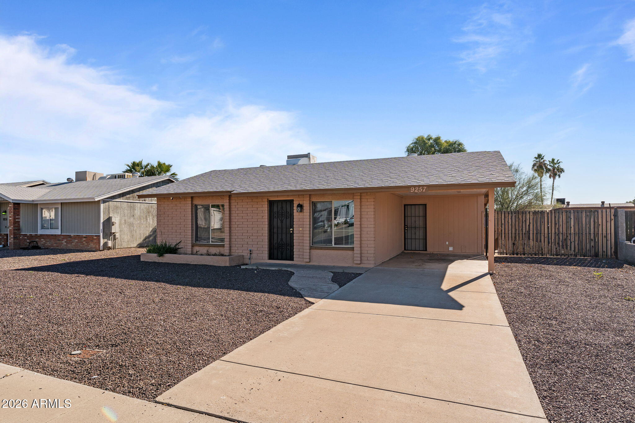 9257 West Gary Road Peoria, AZ 85345 - Photo 5 of 28 a front view of a house with a yard and garage