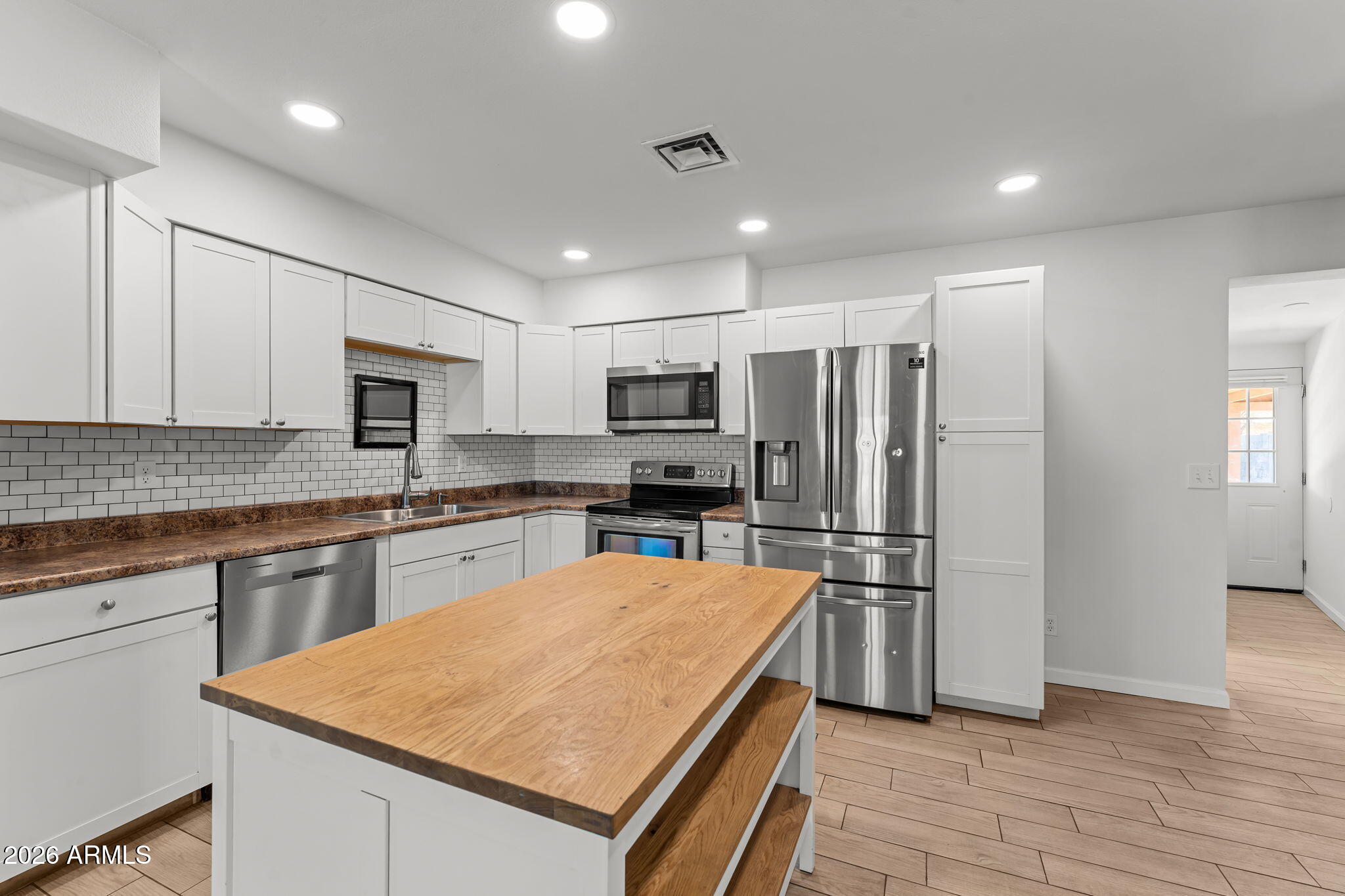 9257 West Gary Road Peoria, AZ 85345 - Photo 7 of 28 a kitchen with stainless steel appliances granite countertop a refrigerator stove microwave and sink