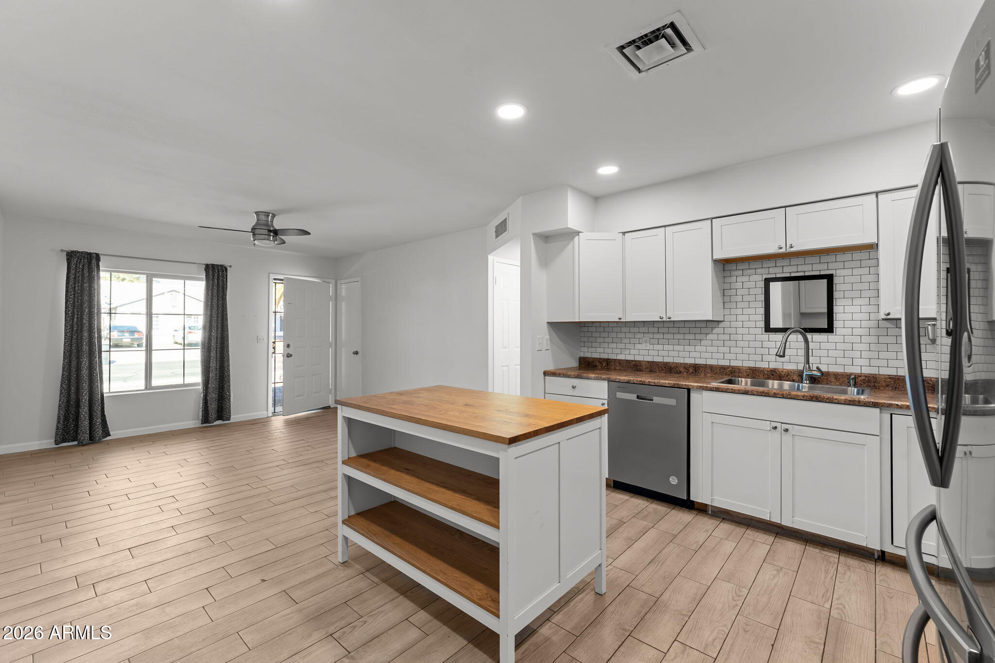 9257 West Gary Road Peoria, AZ 85345 - Photo 8 of 28 a kitchen with stainless steel appliances granite countertop stove a sink dishwasher and a refrigerator