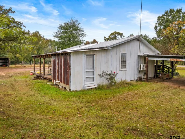 a view of a house with a yard and tree