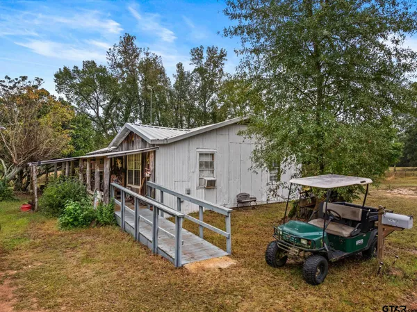 a view of a wooden chairs and table in the patio