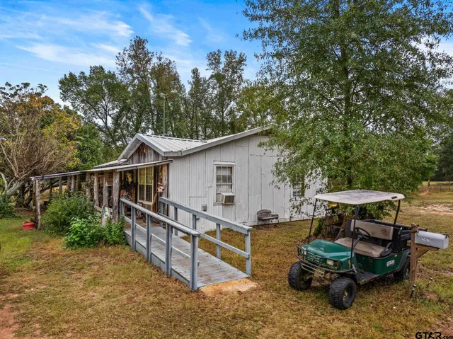 a view of a wooden chairs and table in the patio