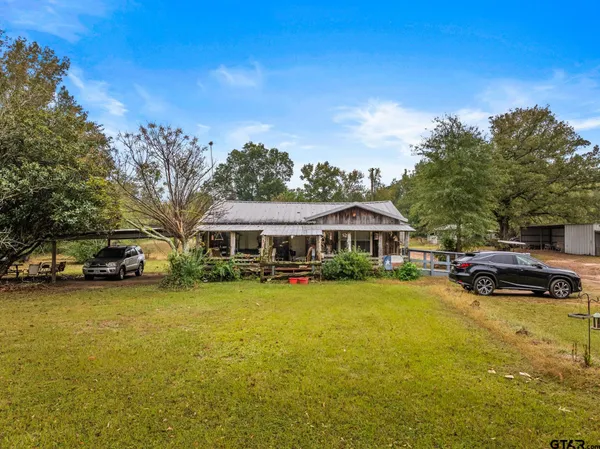 a view of a house with swimming pool and sitting area