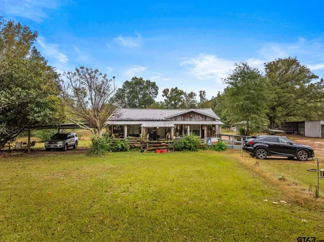 a view of a house with swimming pool and sitting area