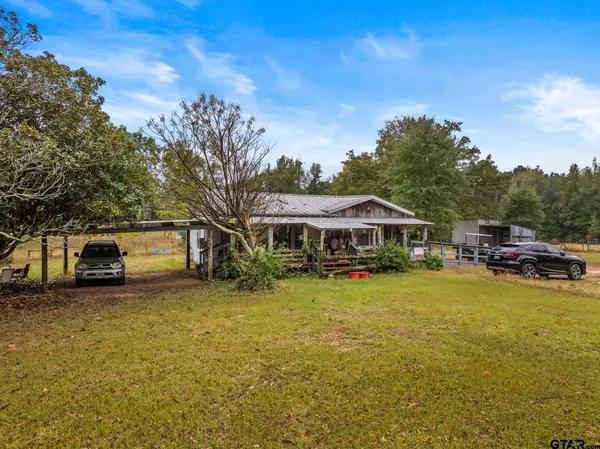 a living room with furniture a fireplace and a chandelier
