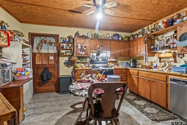 a open kitchen with stainless steel appliances granite countertop a sink and cabinets