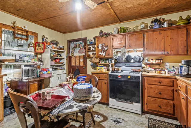 a kitchen with stainless steel appliances granite countertop a stove and cabinets
