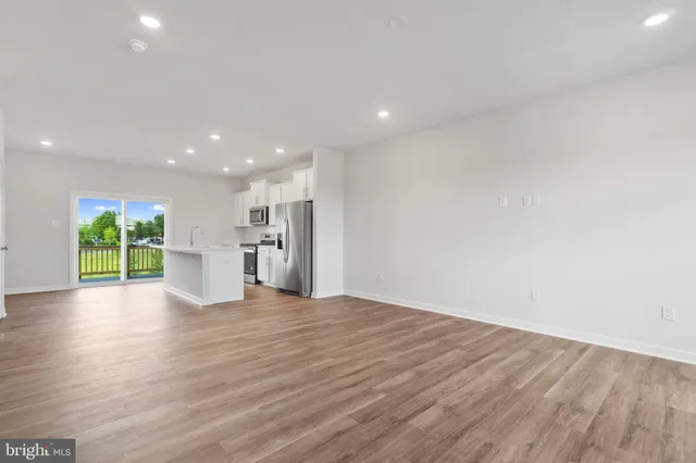 a view of kitchen with wooden floor and windows