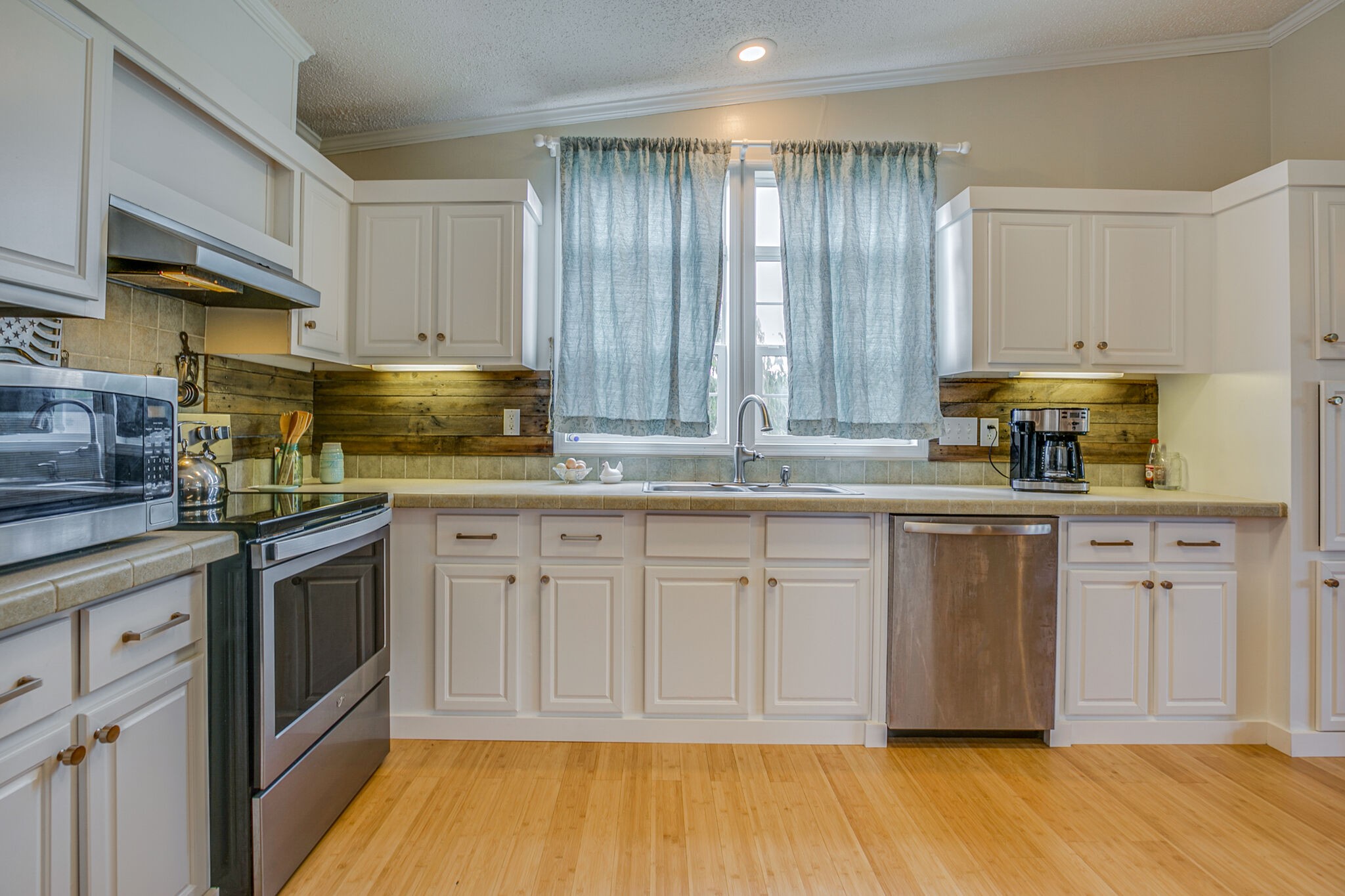 612 Norene Road Lebanon, TN 37090 - Photo 12 of 31 a kitchen with stainless steel appliances granite countertop a stove a sink and white cabinets