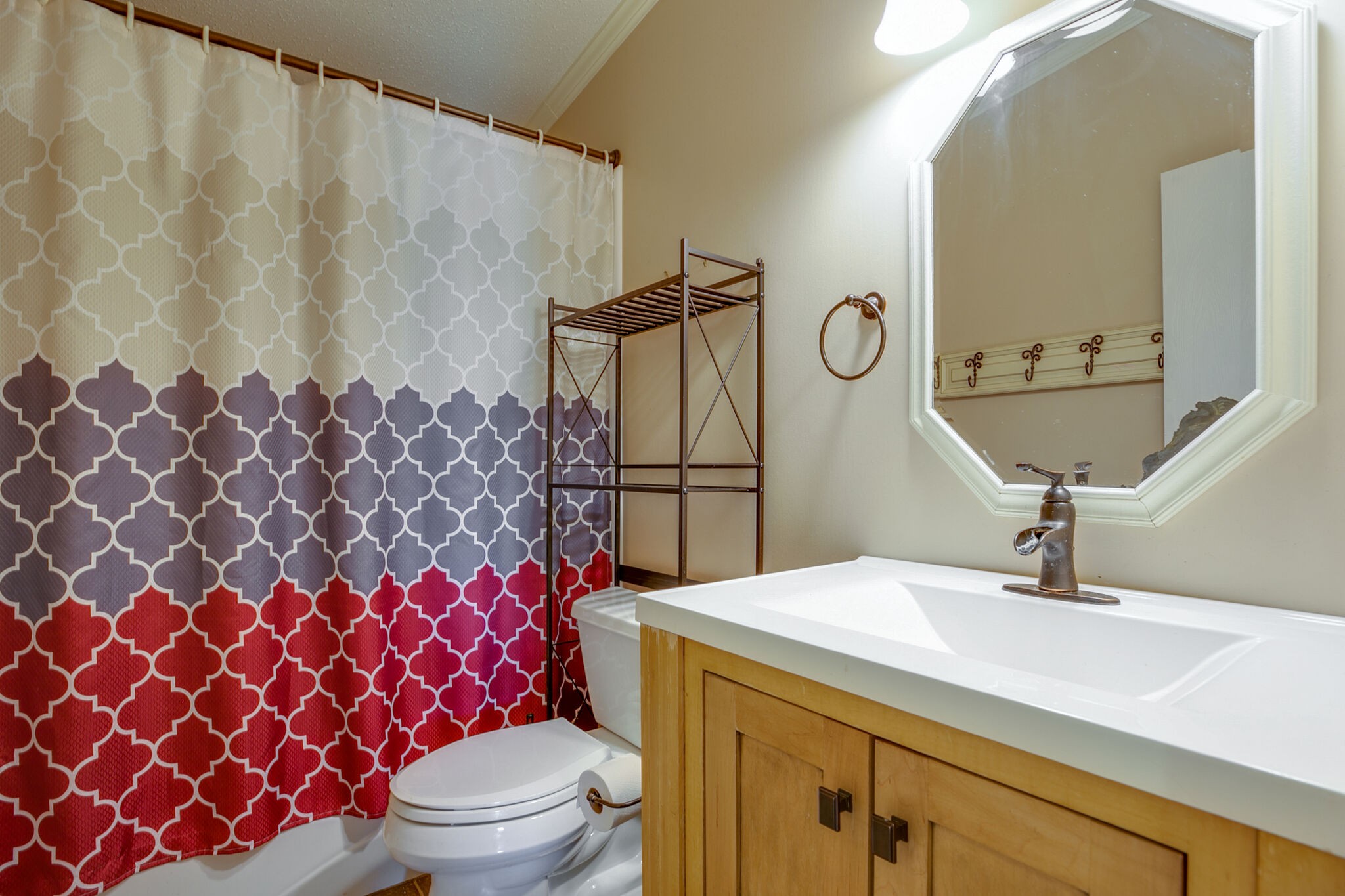 612 Norene Road Lebanon, TN 37090 - Photo 15 of 31 a bathroom with a sink a toilet a mirror and shower curtain