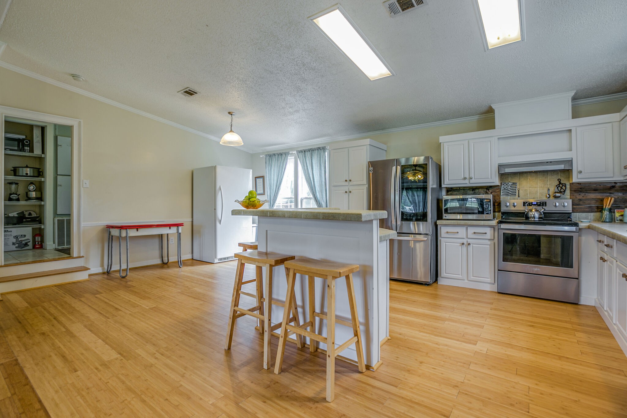 612 Norene Road Lebanon, TN 37090 - Photo 7 of 31 a kitchen with stainless steel appliances kitchen island granite countertop a dining table chairs and granite counter tops