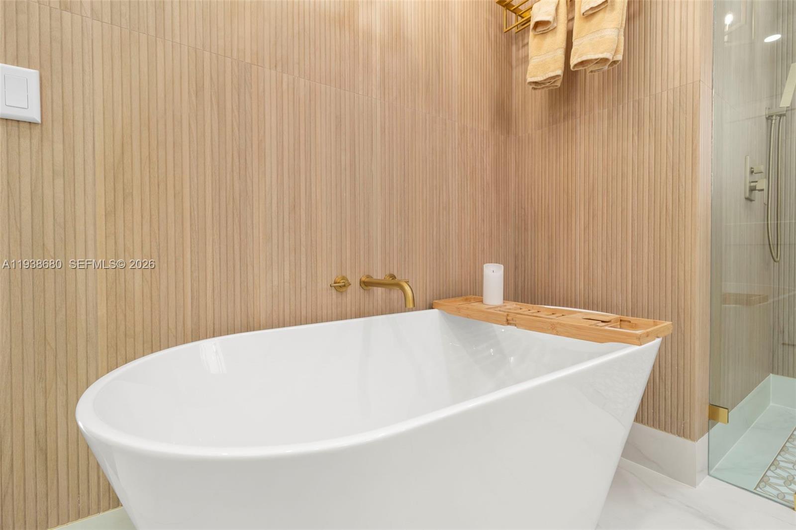 3540 Northeast 28th Avenue Lighthouse Point, FL 33064 - Photo 28 of 47 a white bath tub sitting under a white curtain