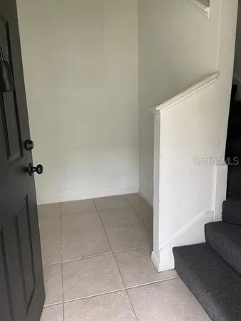 a kitchen with granite countertop a refrigerator and a sink