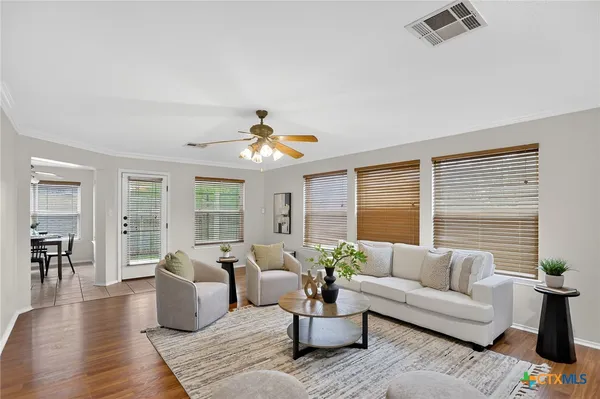 a living room with furniture and wooden floor