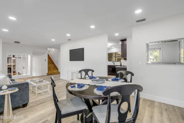 a kitchen with kitchen island wooden floors and stainless steel appliances