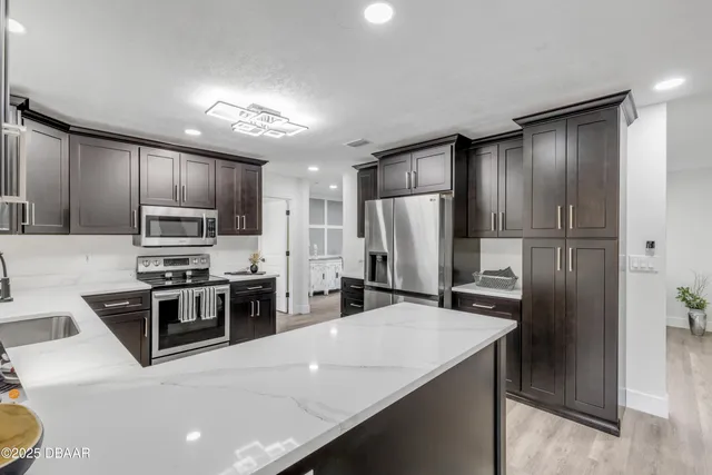 a kitchen with stainless steel appliances a refrigerator and a sink
