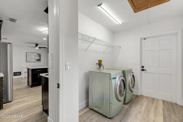 a view of living room and kitchen with a fireplace